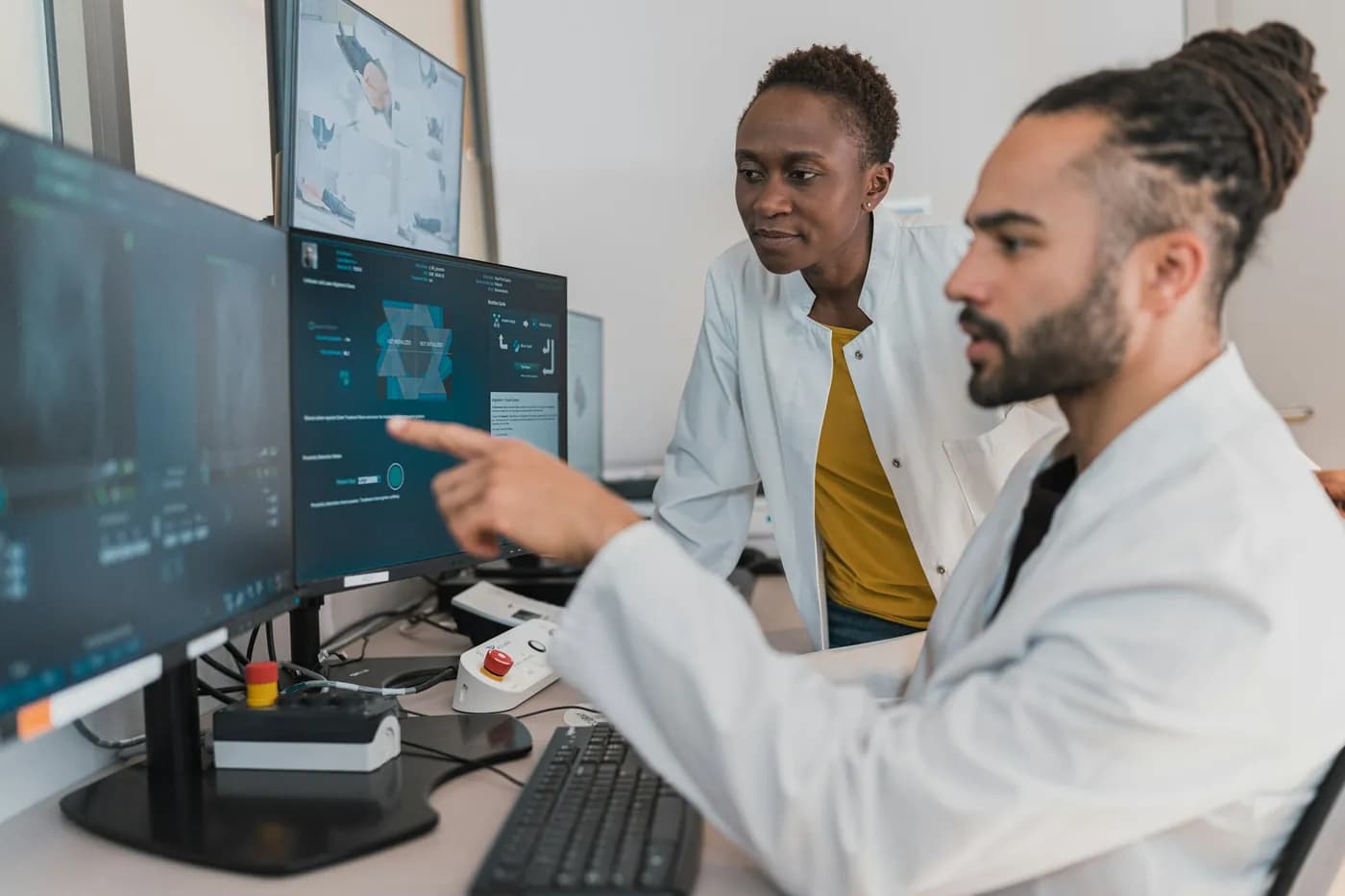 Two doctors reviewing scans on a monitor