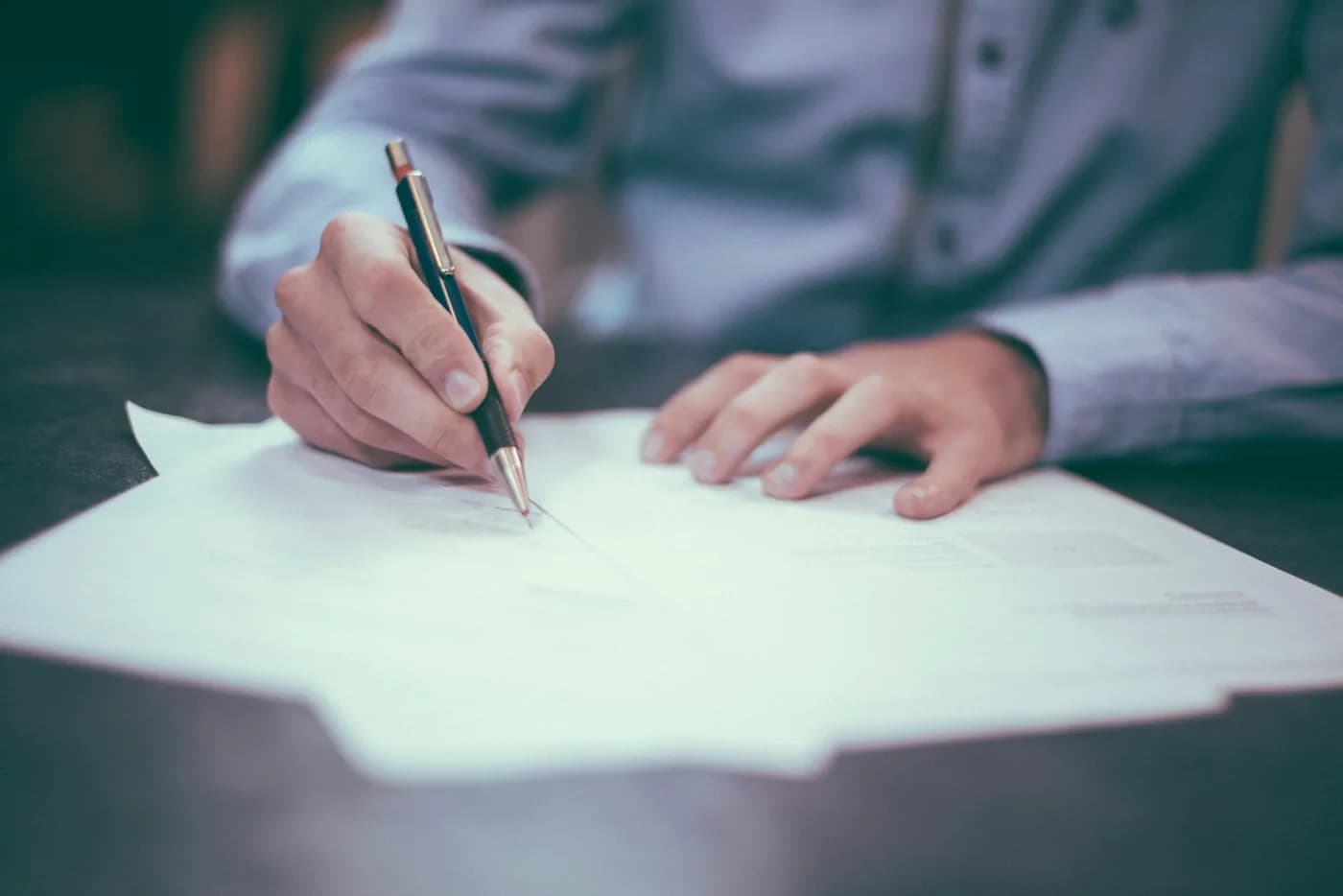 A doctor signing a partnership agreement
